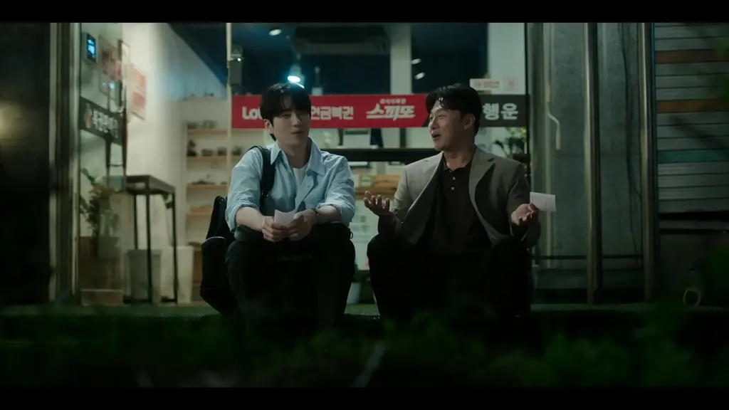 Seon-hyeok and Eun-tae sharing a laugh outside the lottery shop in Episode 5