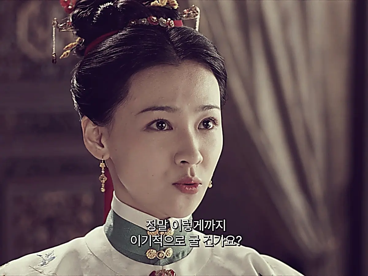 You Wan styled in an embroidered white robe with high collar and ornate gold hairpins