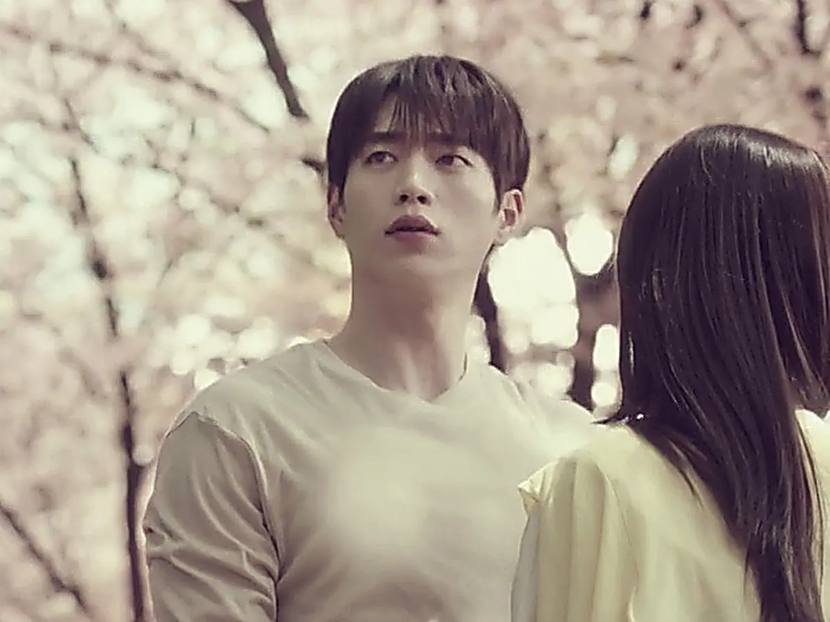 Namgoong Ho in a textured long-sleeve knit walking alongside Park Soo-ah under cherry blossoms