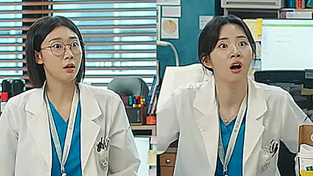 Two female medical residents seated at desks in an office staring in shock with wide eyes