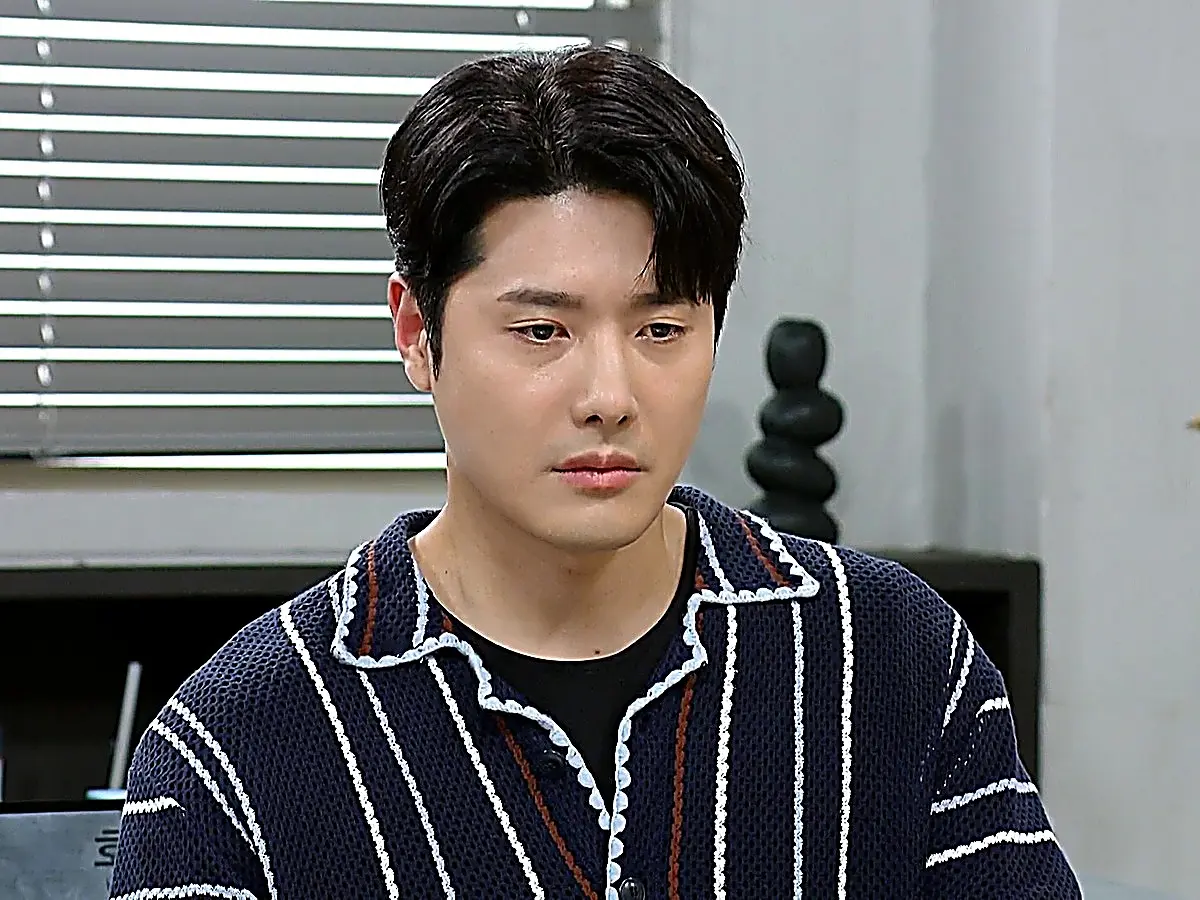 Ko Min-ho in a navy striped knit polo shirt