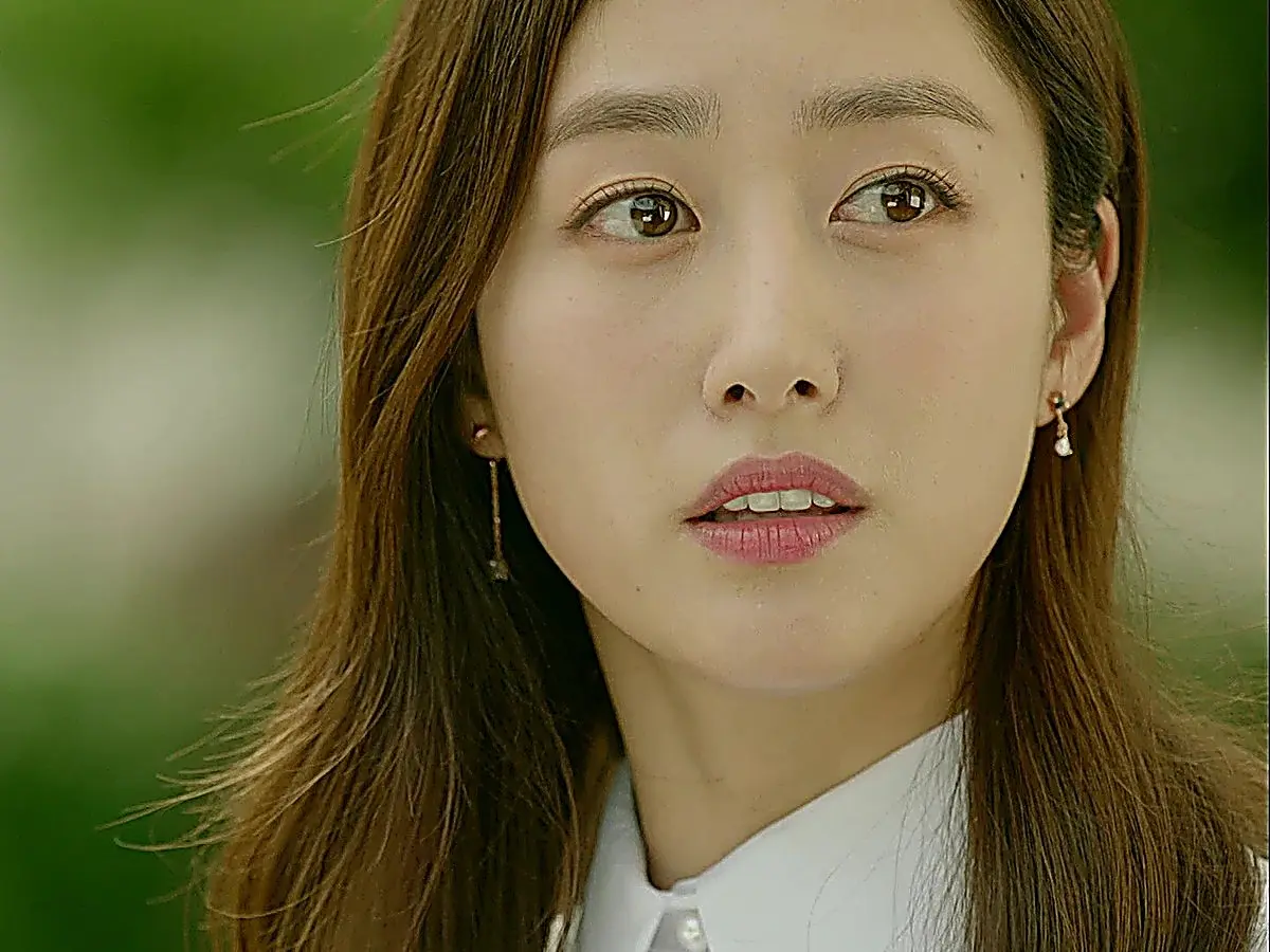 The other Oh Hae-young wearing a white collared blouse with drop earrings
