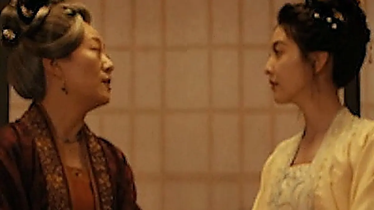Guo Yanlong seated with Great-Aunt Guo in a traditional hall