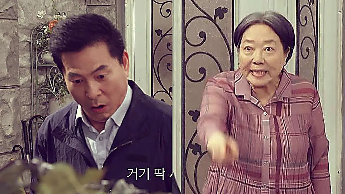 A startled man in a dark jacket on the left and an older woman in a checkered shirt pointing forward on the right