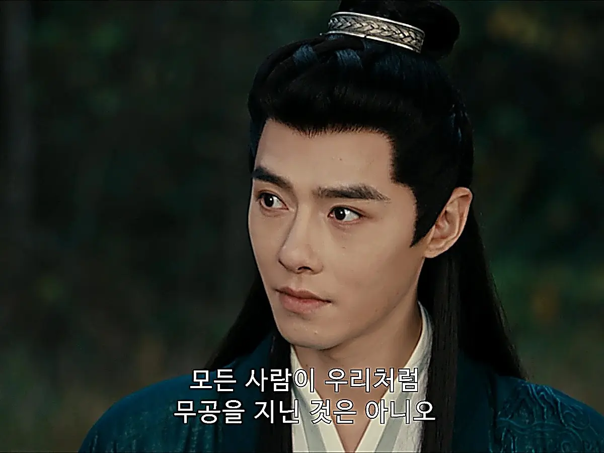 Zhan Zhao speaking in deep teal robes with a high ponytail