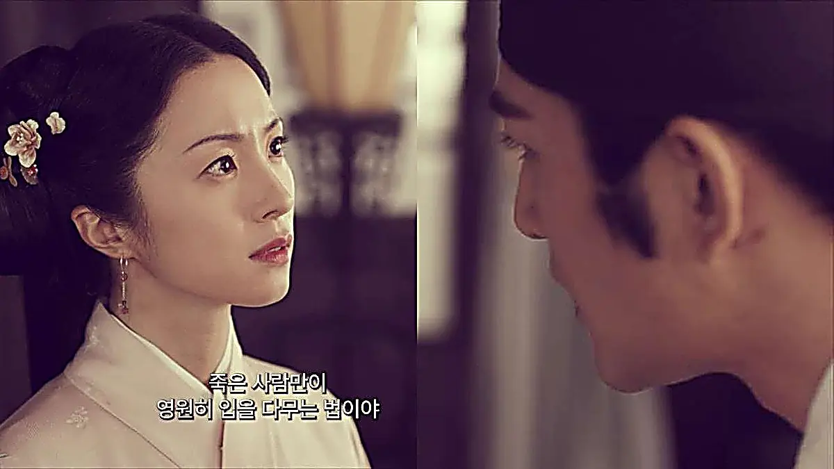 Two people facing each other in close profile indoors