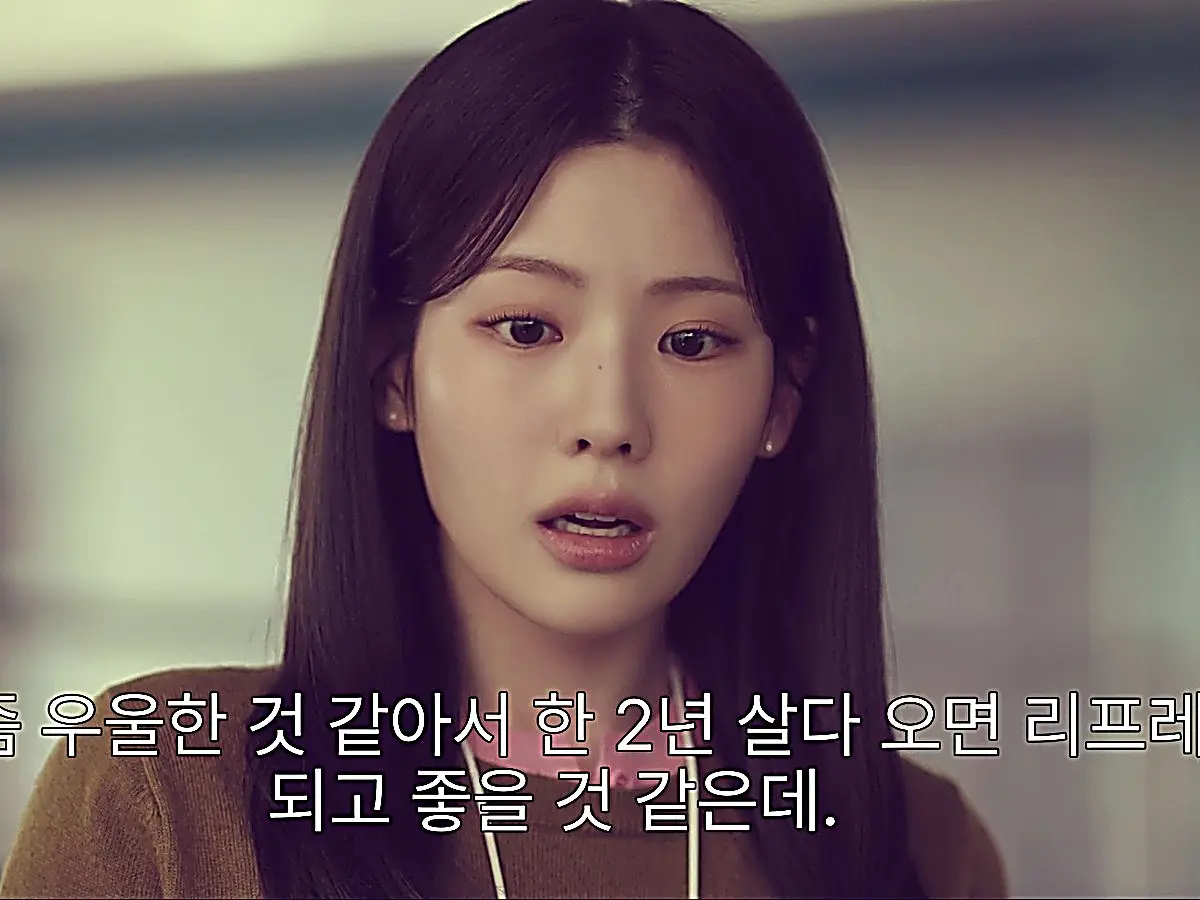 Lee Mi-do wearing a warm camel crewneck sweater over a soft collared shirt