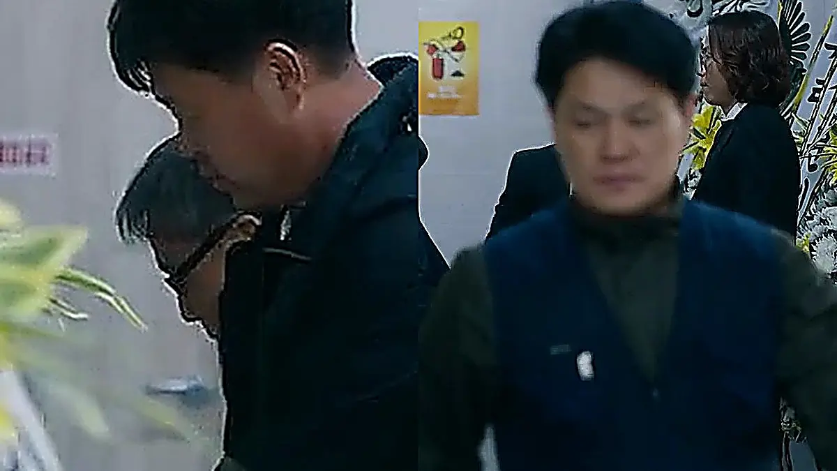 Sang-hoon looking at the memorial wreaths lining the funeral hall