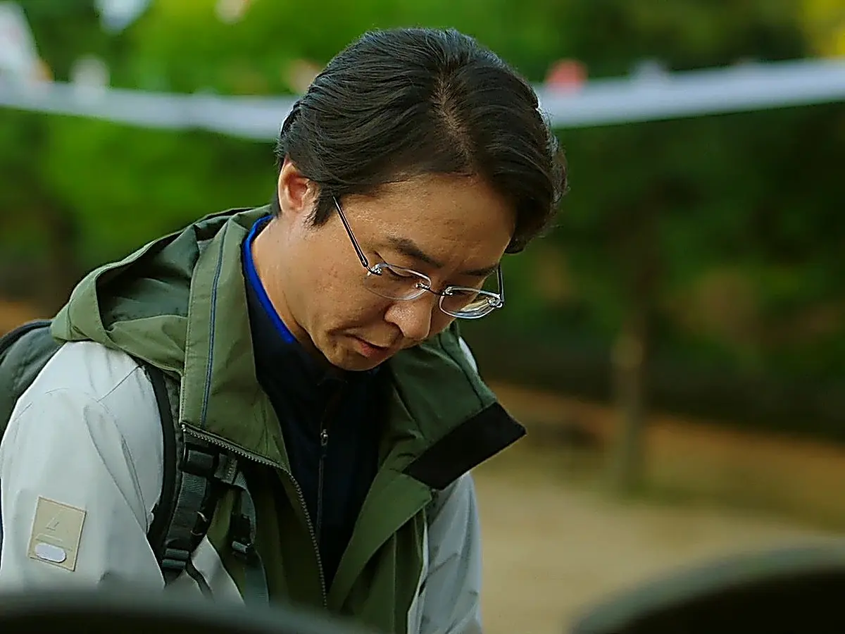 Department head Jang Kyung-chul hangs a prayer strip wishing happiness for Eun-tae at a temple