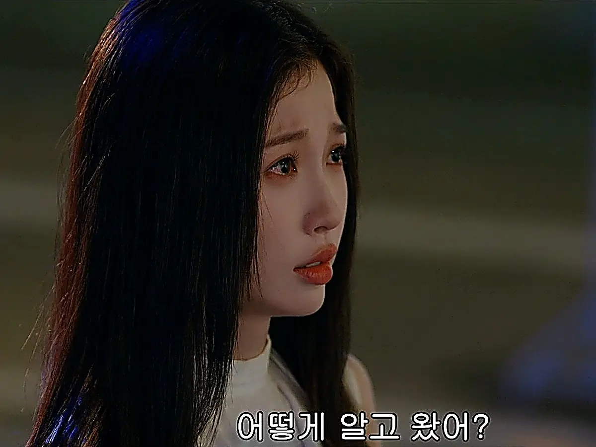Jiang Mu wearing a white sleeveless top with dark straight hair