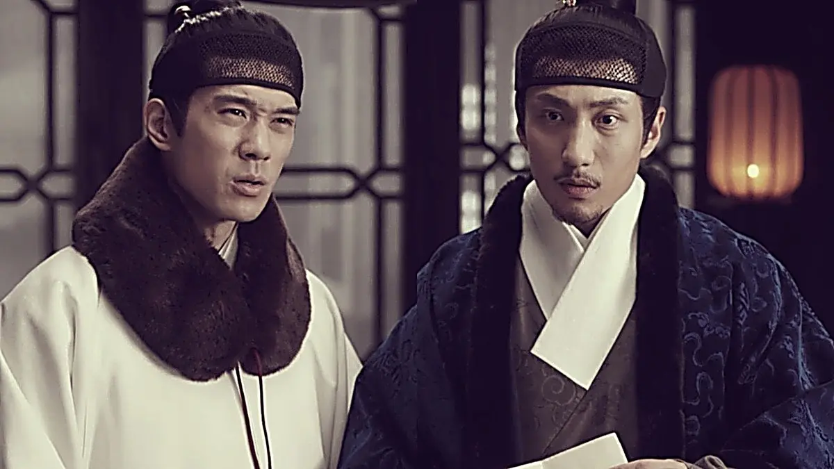 Qi family members in brocade winter robes with contrasting fur collars