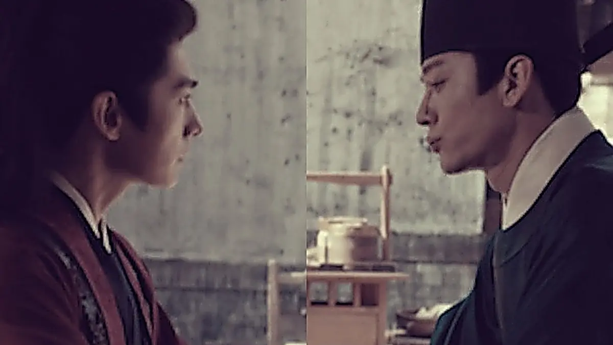 Zhan Zhao in a deep crimson robe sitting across from Hu Xiaotian