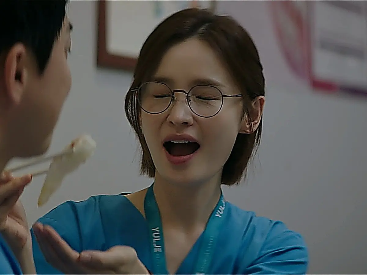 Chae Song-hwa laughing shyly while sharing dinner with Lee Ik-jun
