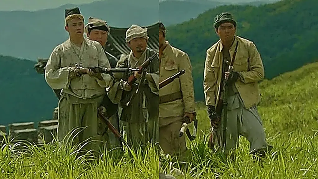 Korean righteous army fighters holding rifles and standing together on a grassy mountain slope