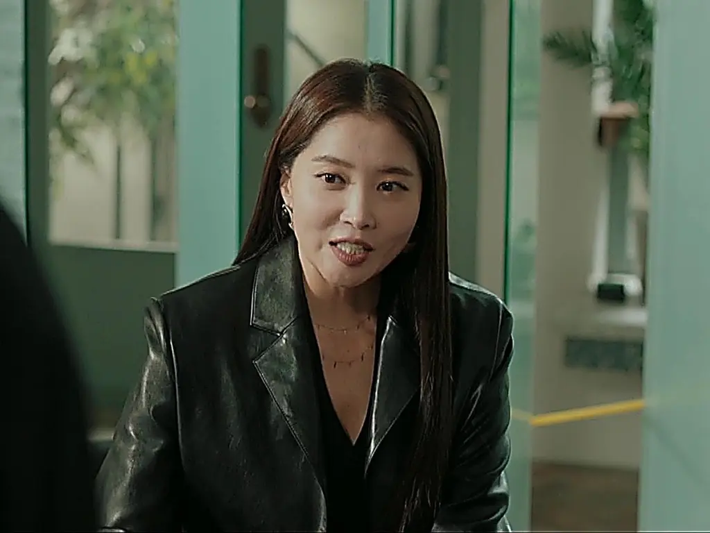 Michelle wearing a tailored black blazer with structured notch lapels in an office setting