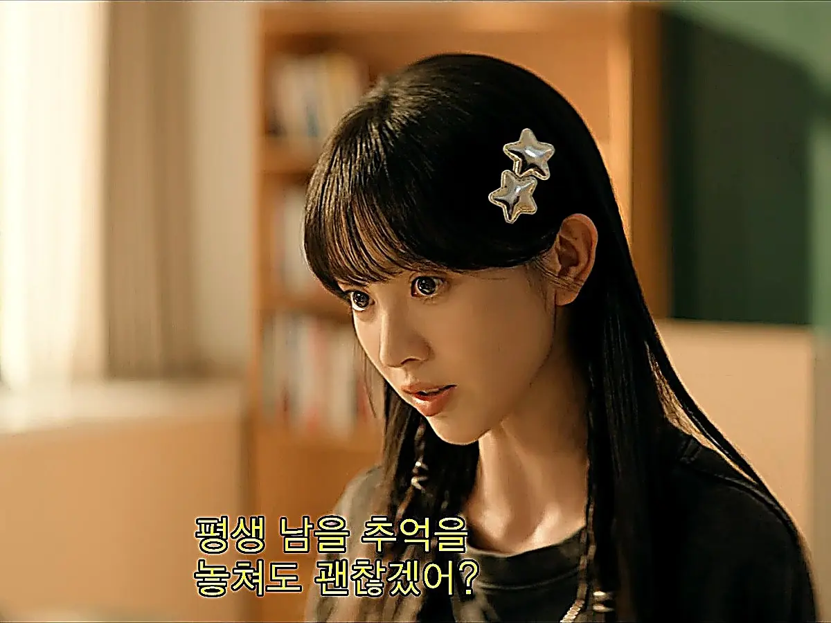 A young woman with straight bangs and two star hair clips speaking in a room