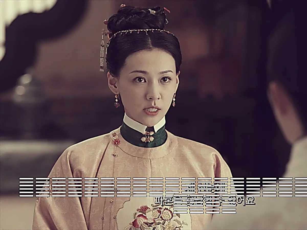 Liu Wan wearing a high-collar peach embroidered gown