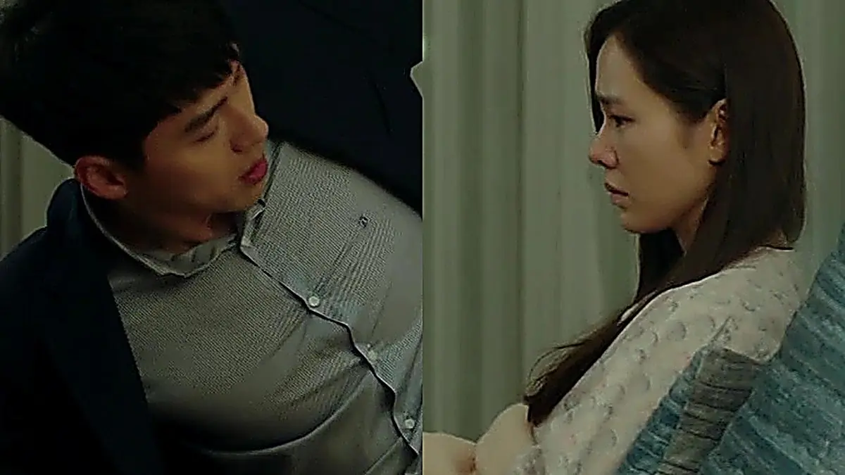 Ri Jeong-hyeok in a navy tailored suit jacket lifting his inner shirt beside Yoon Se-ri