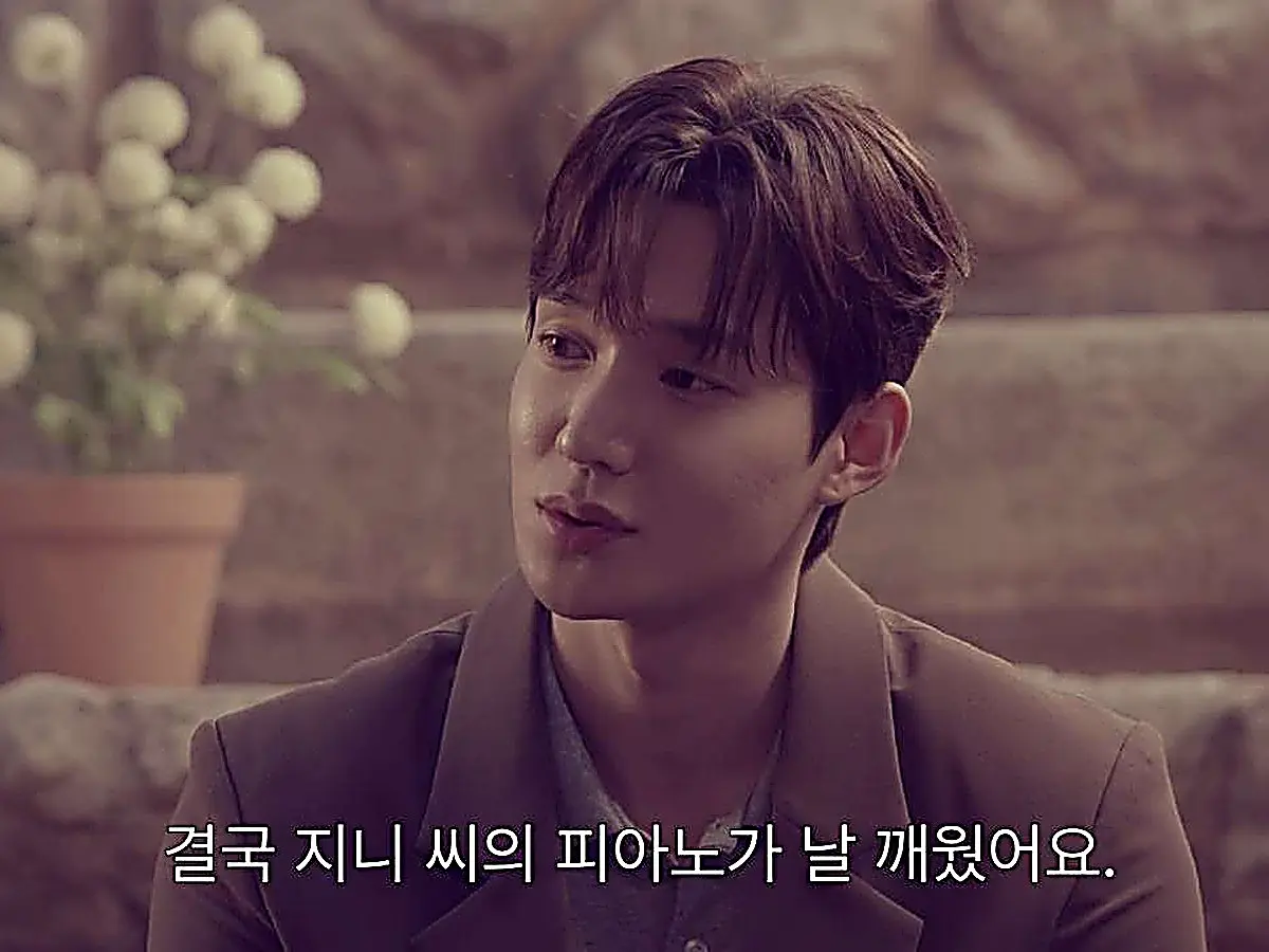 Lim Ji-hoo wearing a brown tailored jacket layered over a grey collared knit polo