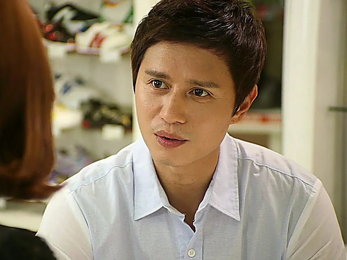 Choi Yoon wearing a light blue button-down shirt
