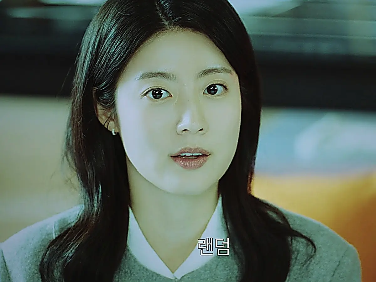 Gong Yeon-soo presenting the random box campaign in a grey v-neck knit layered over a white collar