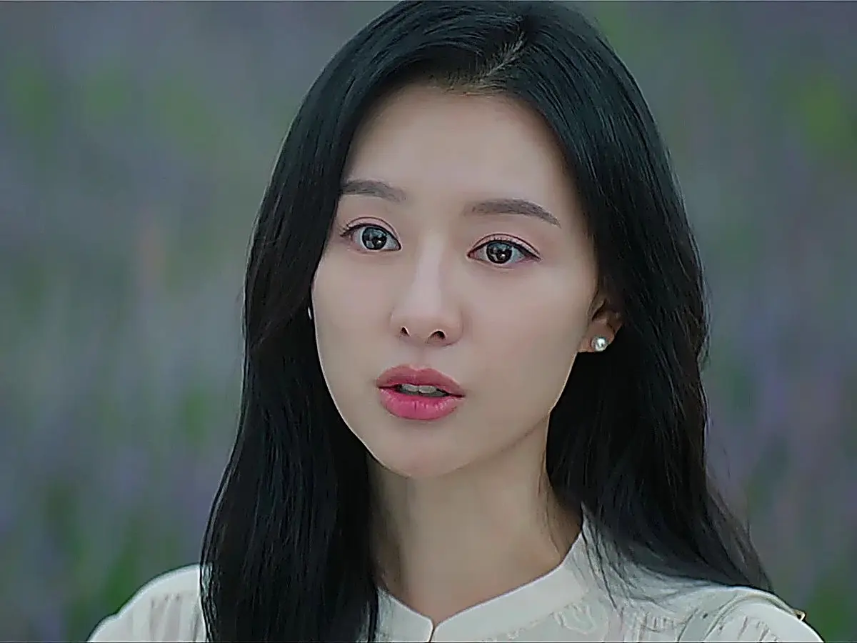 Hong Hae-in wearing an ivory gathered-collar button-front blouse in an outdoor setting