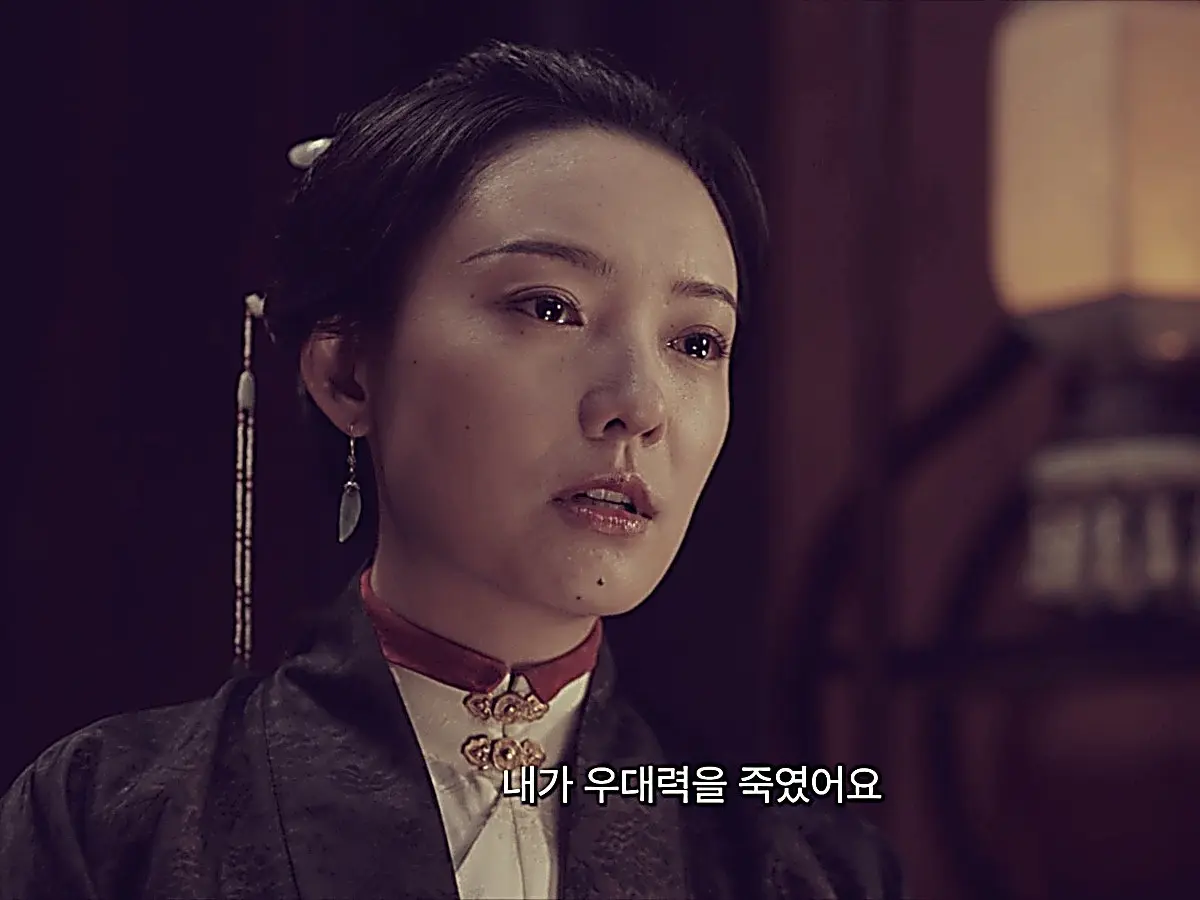 Xue Wenyi in dark patterned gown during the investigation in Under the Moonlight Episode 22