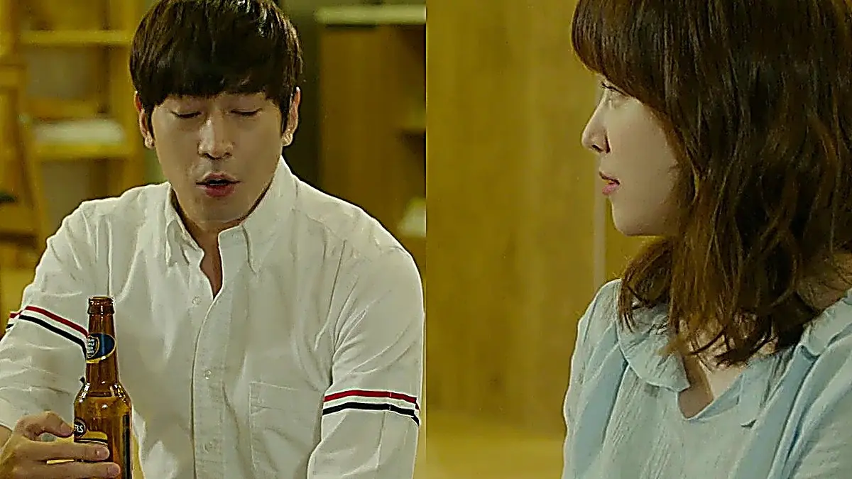 Park Do-kyung in a white button-down shirt seated beside Oh Hae-young
