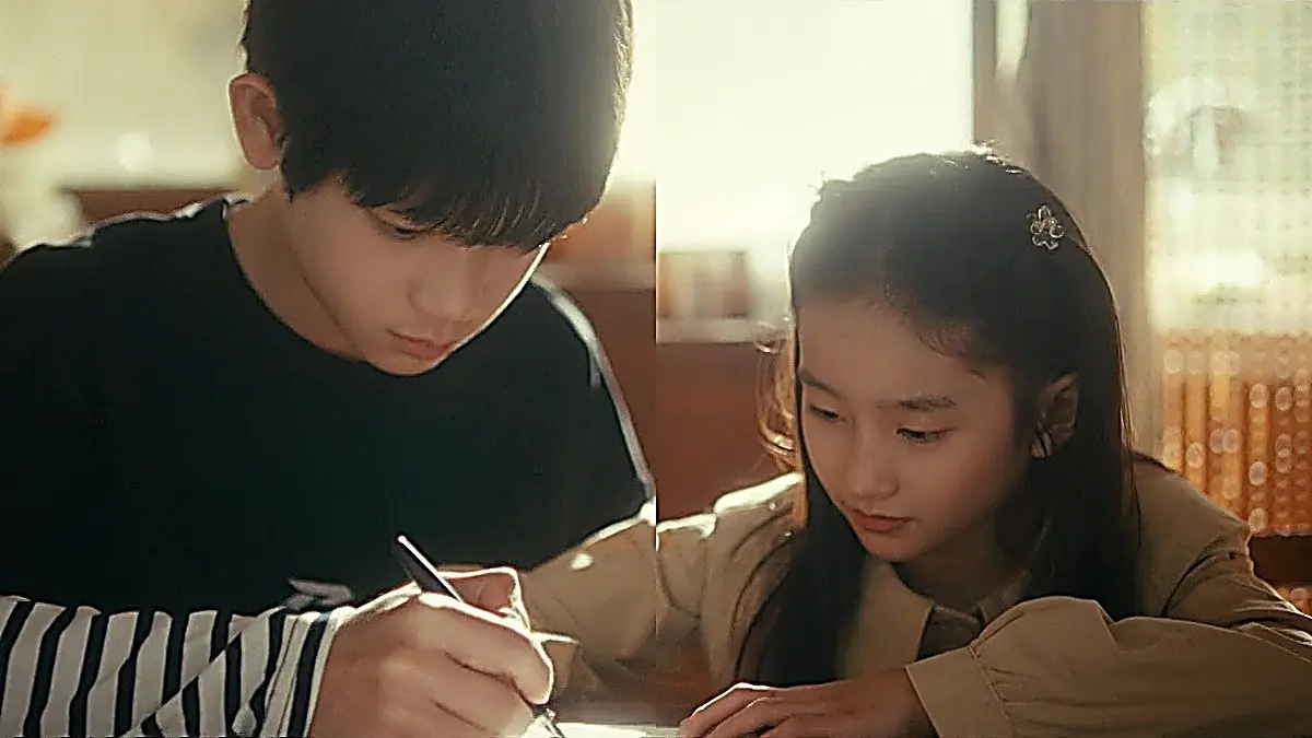 Young Jin Zhao guiding Jiang Mu's hand during a warm childhood memory