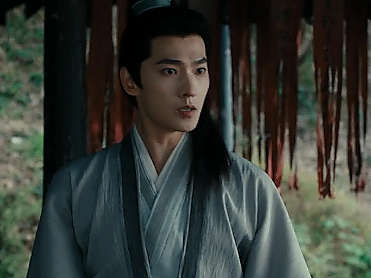 Zhan Zhao in a relaxed light grey crossover robe with a wide dark trim and dark hair wrap