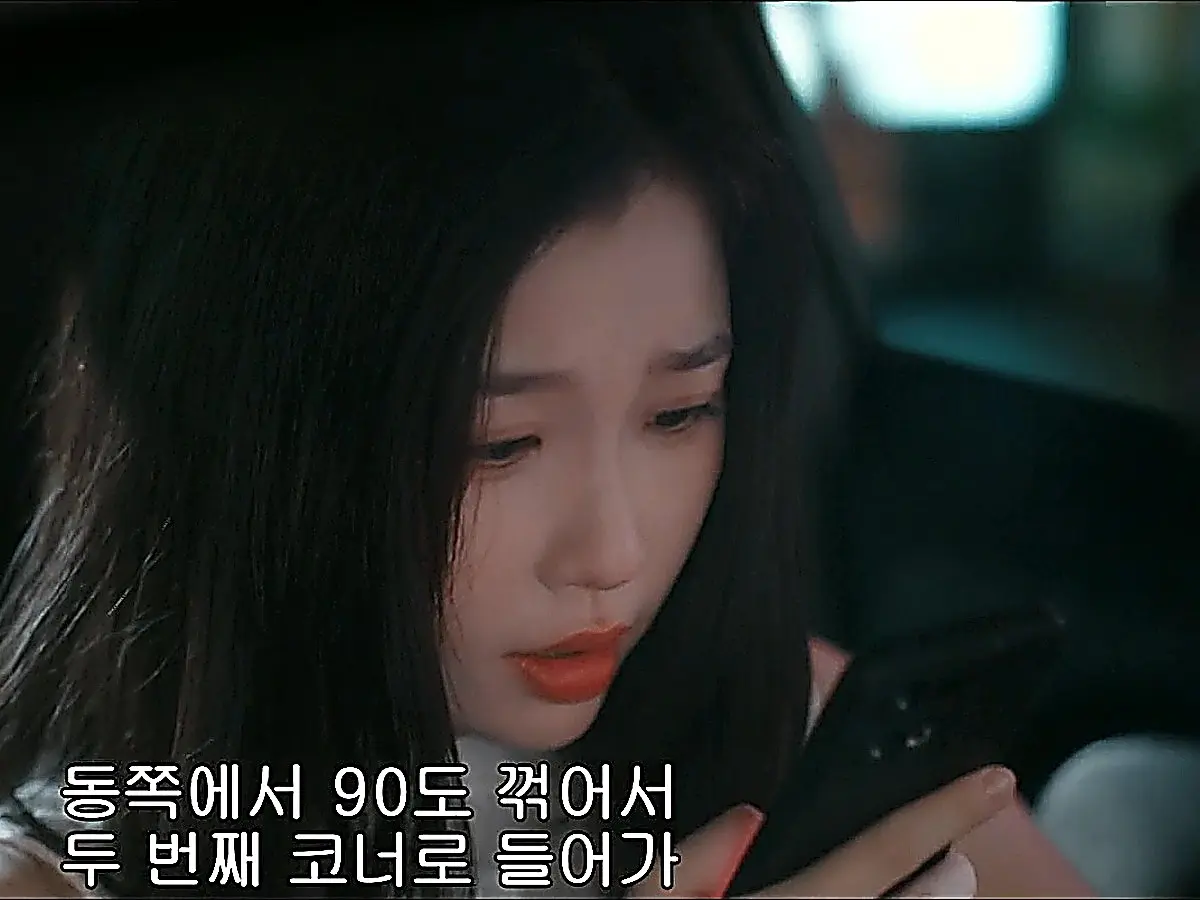 Jiang Mu holding her phone and navigating while Jin Zhao speeds through traffic
