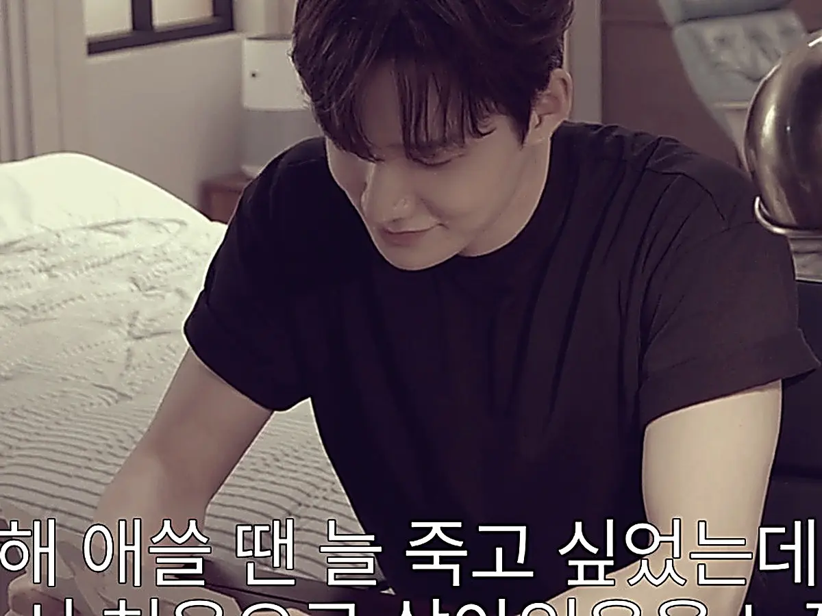 Ji-hoo writing his personal letter in a warmly lit flashback