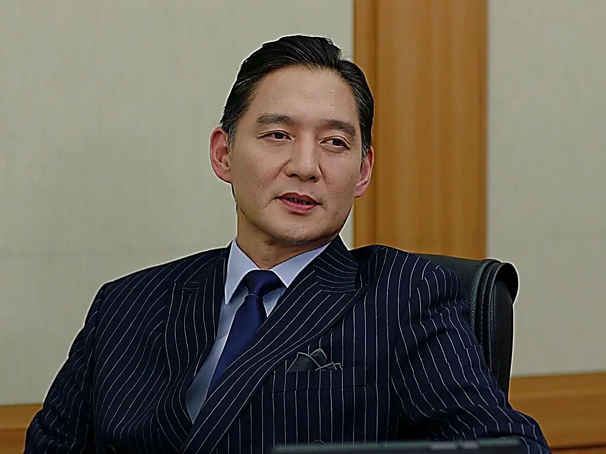 Design evaluation committee seated in pinstripe and double-breasted suits