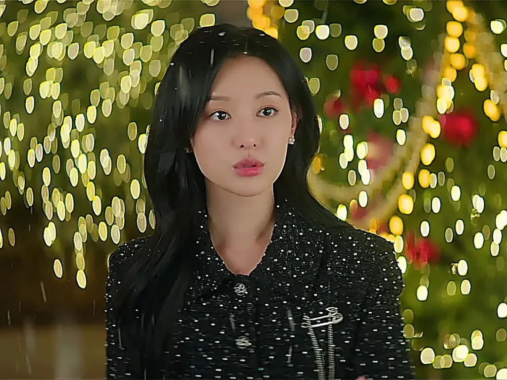 Hong Hae-in staring up at artificial snow falling across the department store plaza
