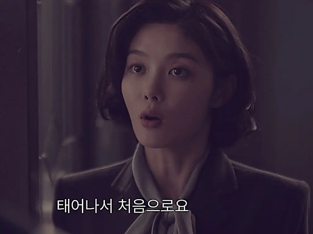 Geum Seo-hee wearing a tailored charcoal blazer and scarf blouse in 100 Days of Lies Episode 3