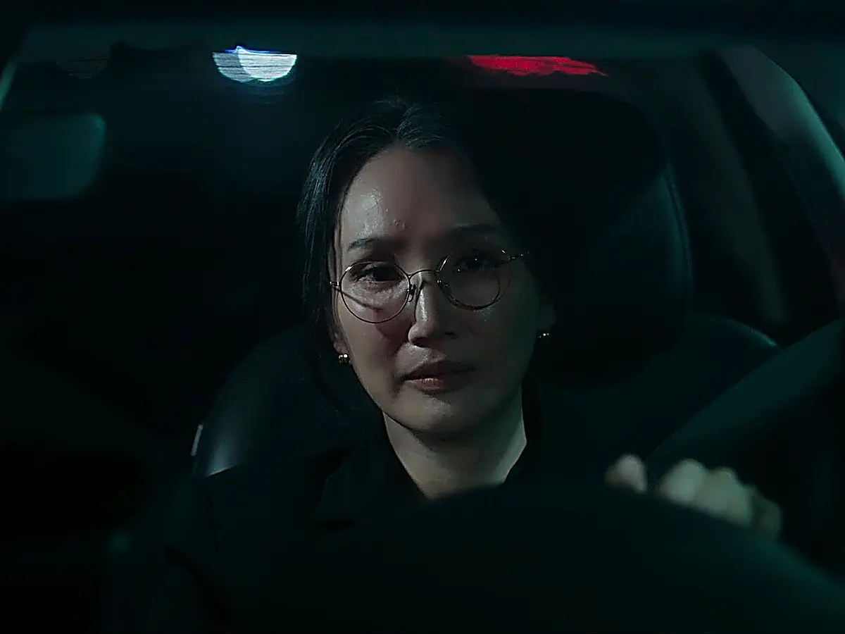 Director Park Hyun-sook sitting alone in her car after missing her daughter's birthday