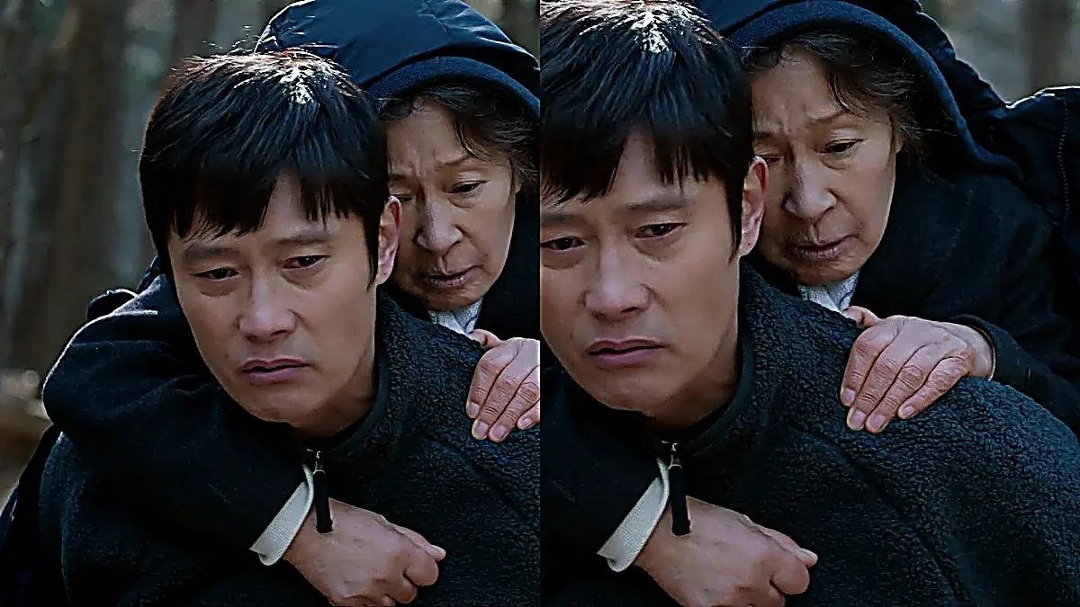 Dong-seok in a charcoal zip-up fleece carrying Ok-dong in Our Blues episode 20
