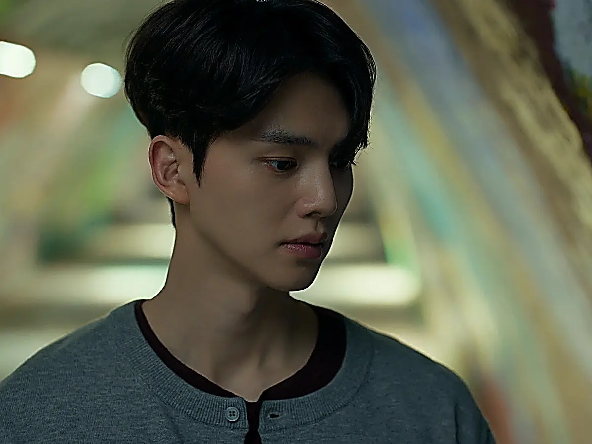 Jeong-yo talking to Bi-o inside a bustling subway corridor