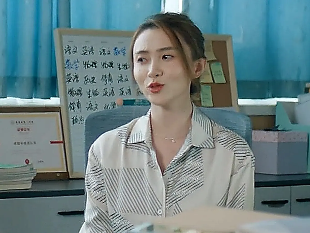 Homeroom teacher in a geometric print collared shirt