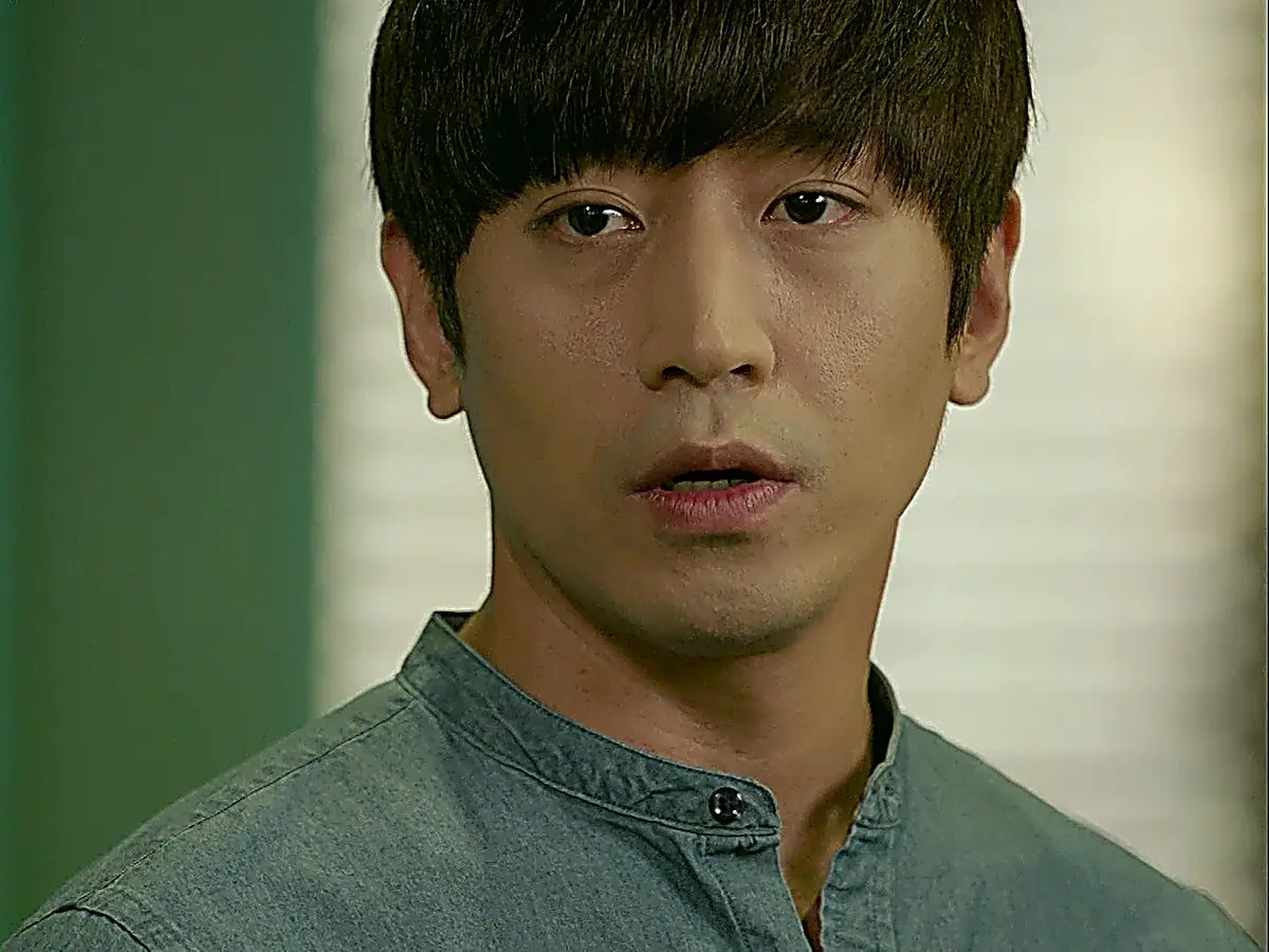 Park Do-kyung wearing a teal chambray band-collar shirt with a top button detail