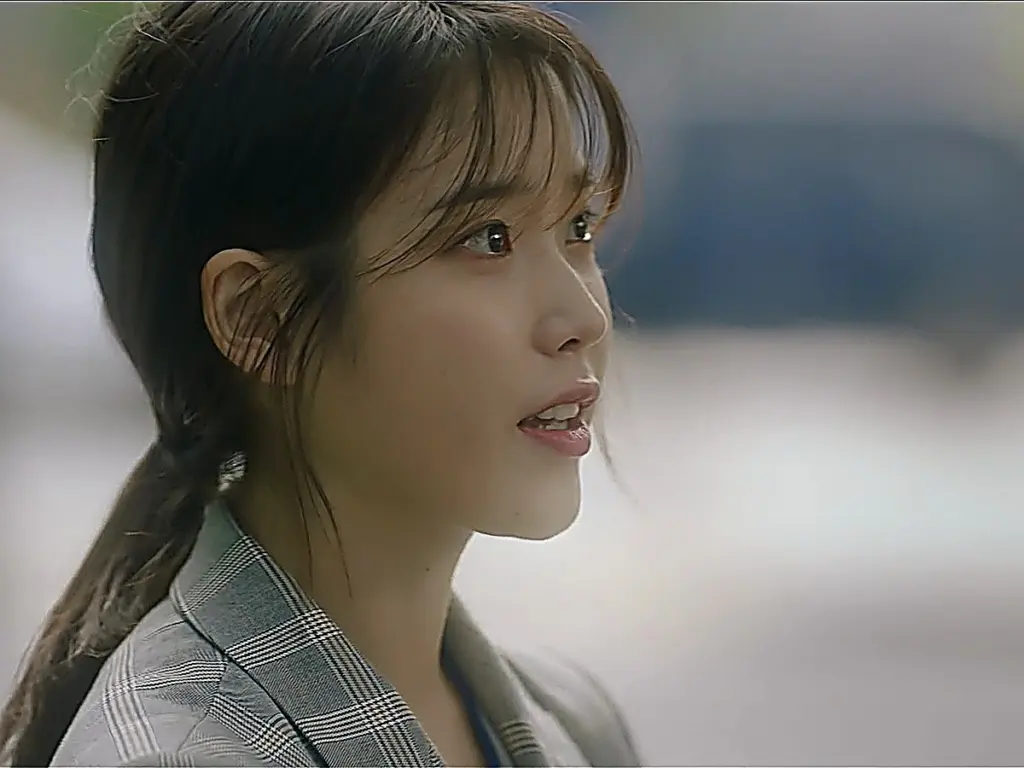 Lee Ji-an smiling in a tailored grey plaid blazer in My Mister episode 16