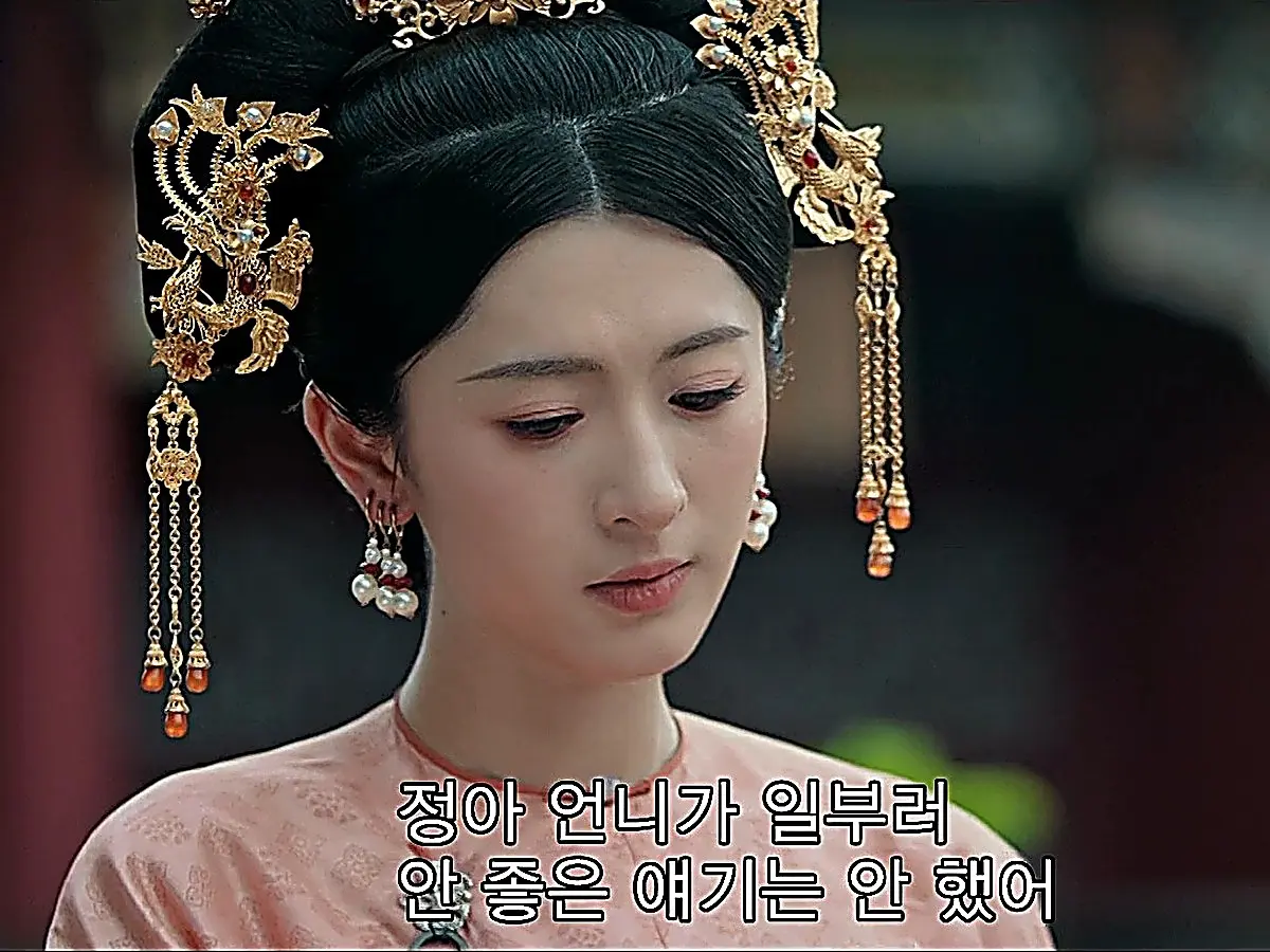 Consort Duan in gold phoenix headdress and pearl drop earrings
