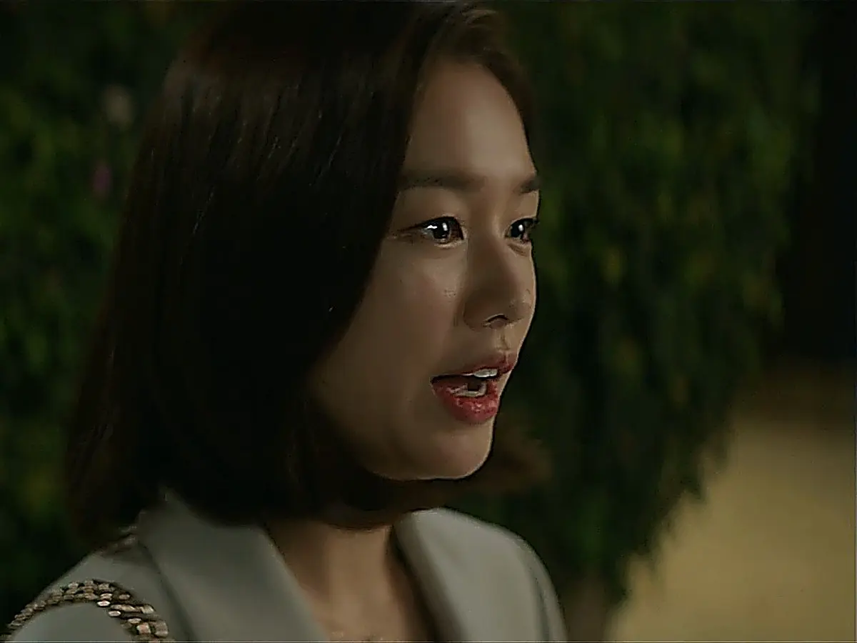 Chu Min-ha standing outdoors in an evening setting wearing a tailored notched-lapel blazer