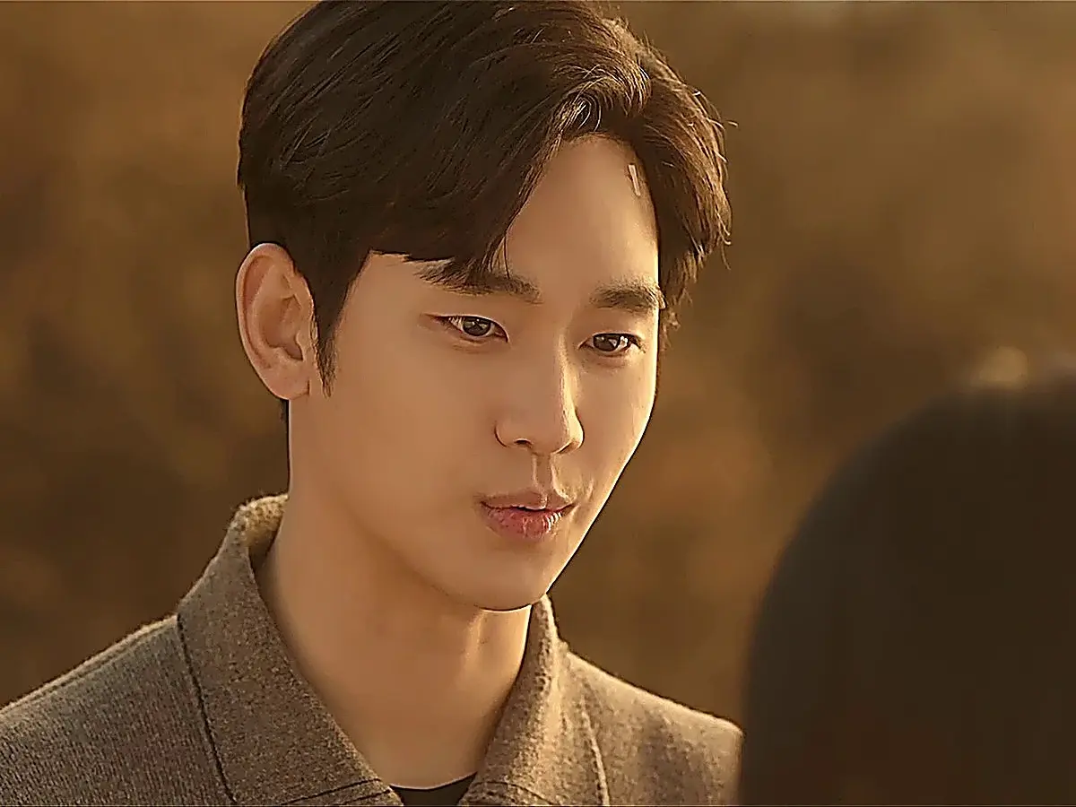 Baek Hyun-woo wearing a textured grey long-sleeve knit polo collar sweater outdoors at sunset