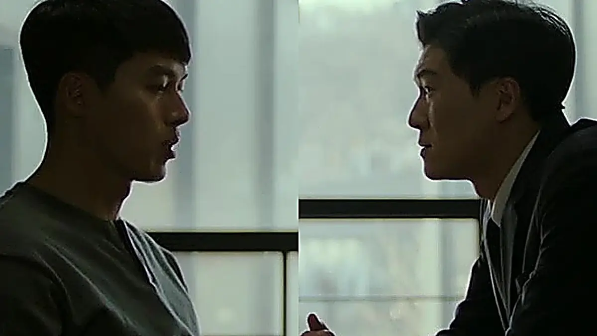 Two men seated across from one another in profile during a formal interrogation.