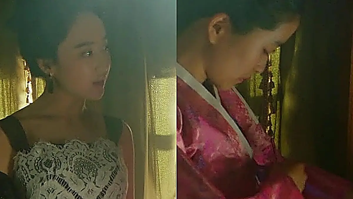 Go Ae-shin untying her hanbok while Kudo Hina stands in a lace corset bodice