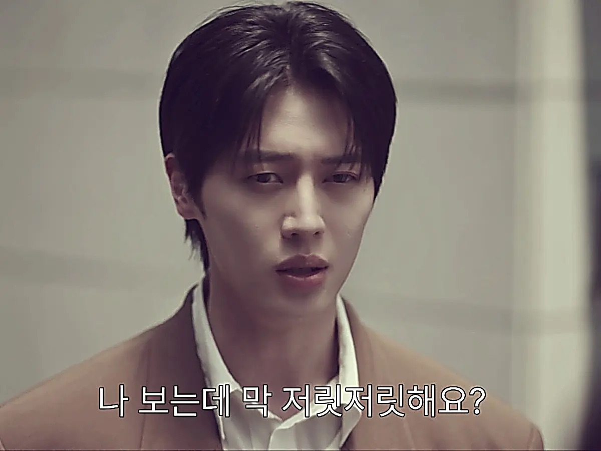 Han Tae-seung wearing a sharp tan double-breasted blazer over a white collared shirt