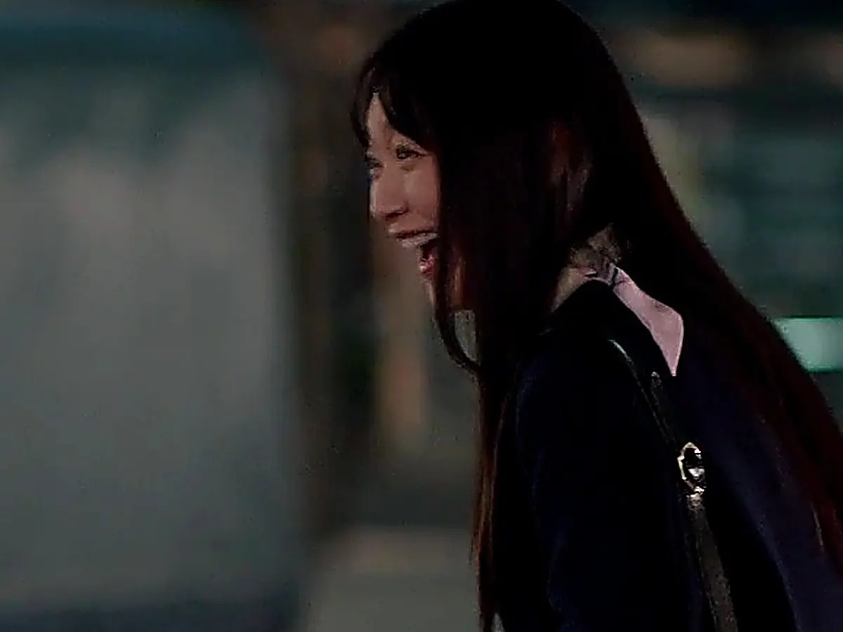 Min Seon-ah smiling on her evening commute wearing structured dark outerwear