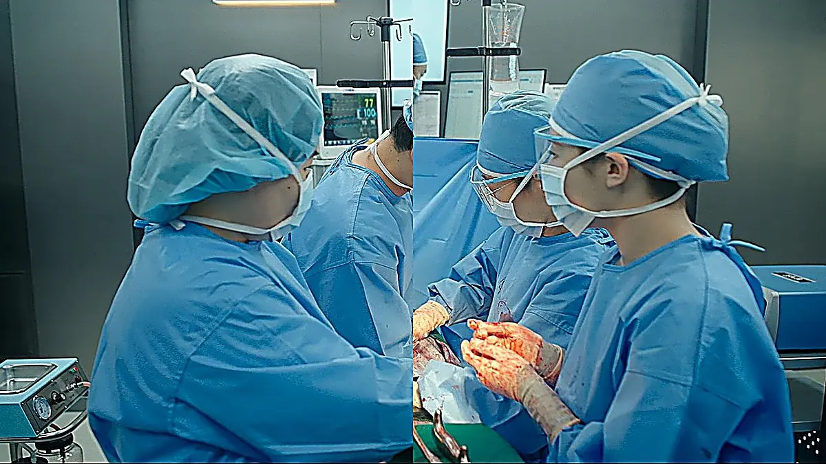 Medical staff in blue sterile surgical gowns, caps, and masks operating in a surgical suite