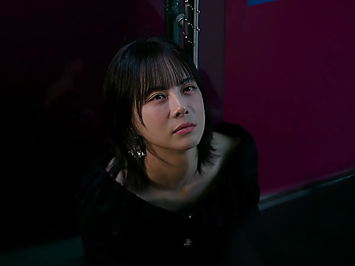 Ahn Hae-ra wearing an off-the-shoulder black top and crystal drop earrings